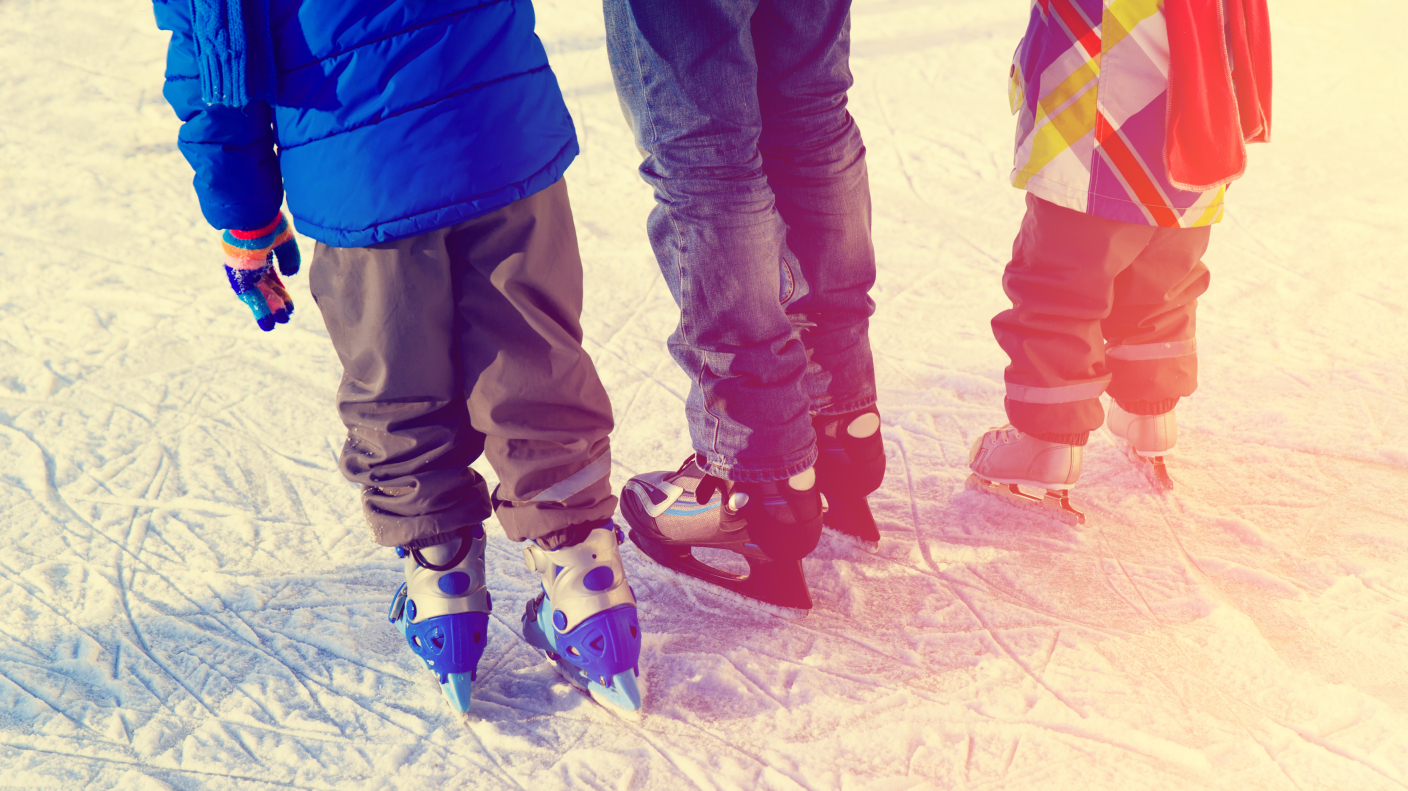 father with two kids skating, family winter sport