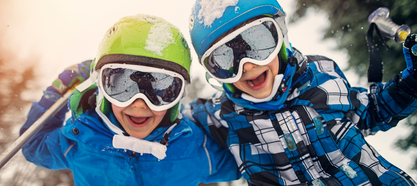Portrait of little skiers  laughing at the camera